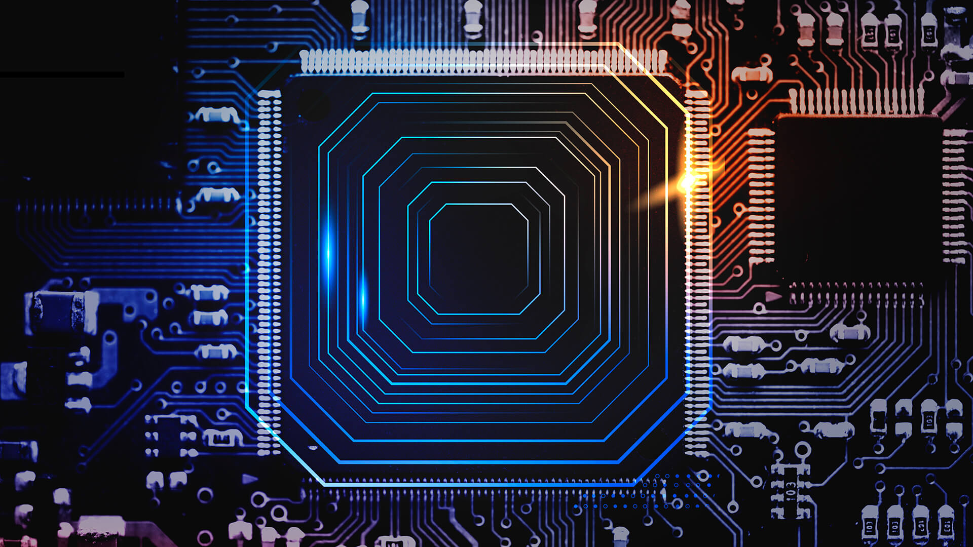 Imagem de um circuito eletr&ocirc;nico com foco em um processador ou chip, iluminado por luzes azuis e laranjas, representando tecnologia avan&ccedil;ada e inova&ccedil;&atilde;o digital.